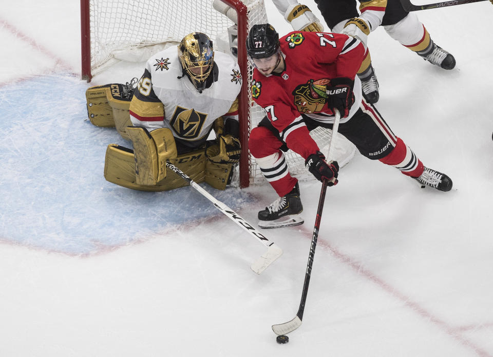 Vegas Golden Knights goalie Marc-Andre Fleury (29) watches as Chicago Blackhawks' Kirby Dach (77) picks up a rebound during the first period of Game 3 of an NHL hockey first-round playoff series, Saturday, Aug. 15, 2020, in Edmonton, Alberta. (Jason Franson/The Canadian Press via AP)