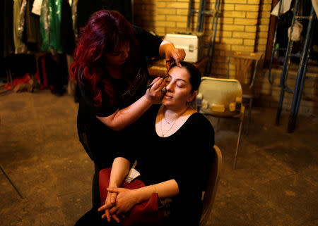 An Iraqi actor has her makeup applied before performing in Òthe hotelÓ, a TV series which is being filmed and broadcast during the Muslim holy month of Ramadan, in Baghdad, Iraq May 12, 2019. Picture taken May 12, 2019. REUTERS/Thaier al-Sudani