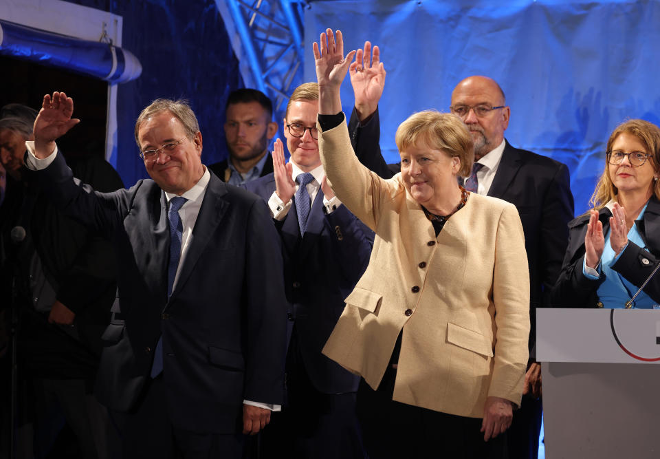 German Chancellor Angela Merkel and Christian Democrats (CDU/CSU) chancellor candidate Armin Laschet (L) greet supporters at the conclusion of an election campaign rally, September 21, 2021, in Stralsund, Germany. / Credit: Sean Gallup/Getty