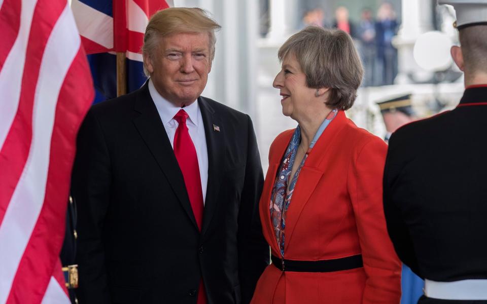 US President Donald Trump greets Theresa May at the White House in January - Credit: EPA