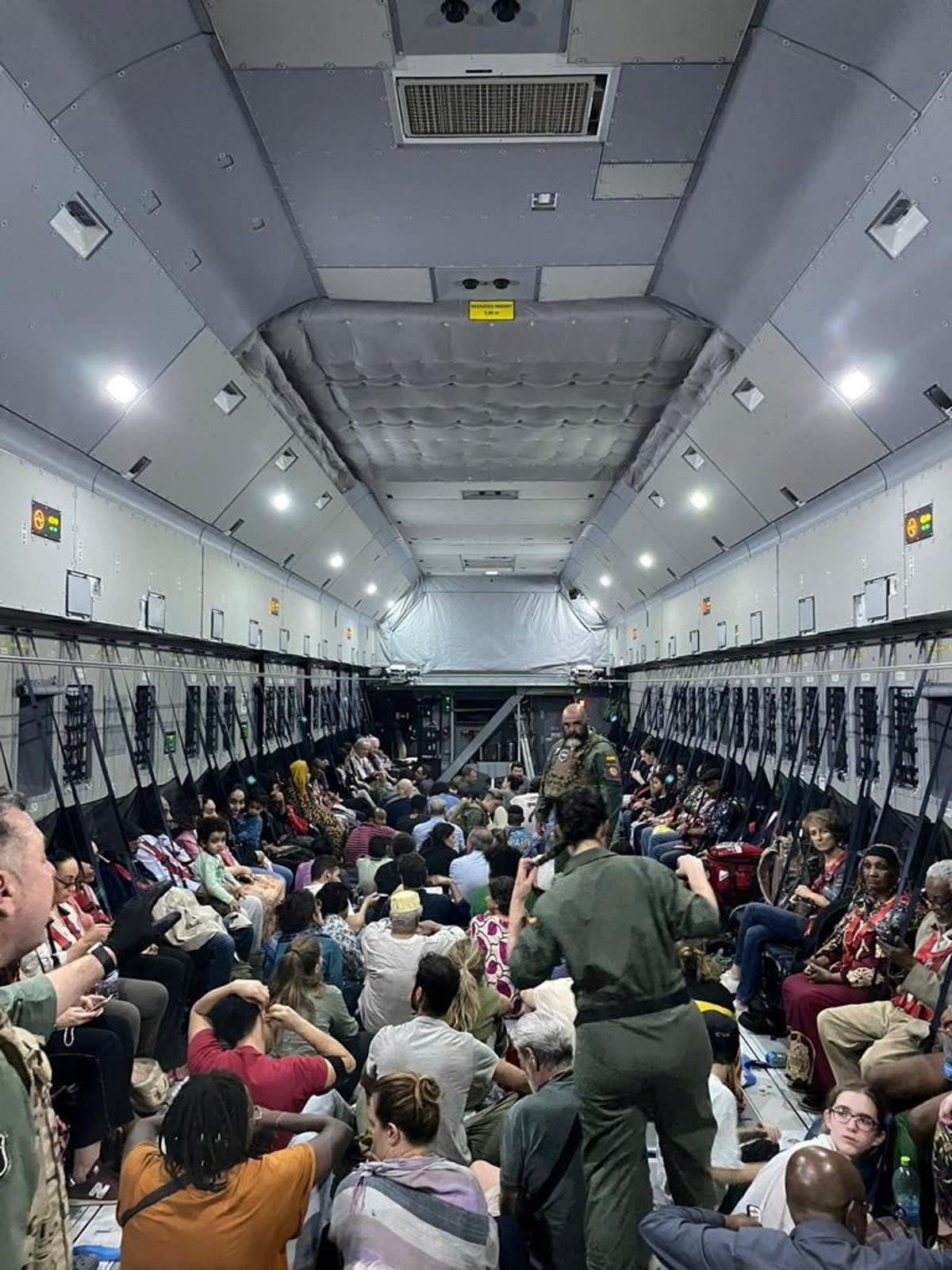 Spanish diplomatic personnel and citizens wait to disembark a military plane after they were evacuated from Sudan (via REUTERS)