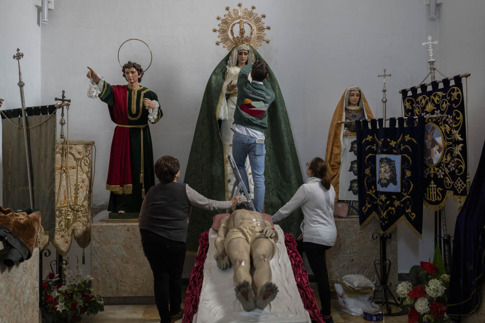 Members of a Catholic brotherhood place back the "Virgen María Santísima de la Esperanza" after the Holy Week procession in the southern town of Quesada, Spain, Saturday, March 30, 2024. (AP Photo/Bernat Armangue)