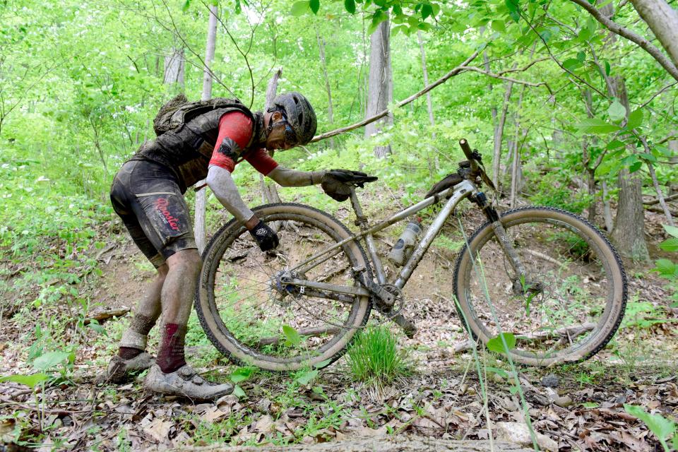 A racer has to put the chain back on their bike during the Mohican Mountain Bike Race on Saturday.