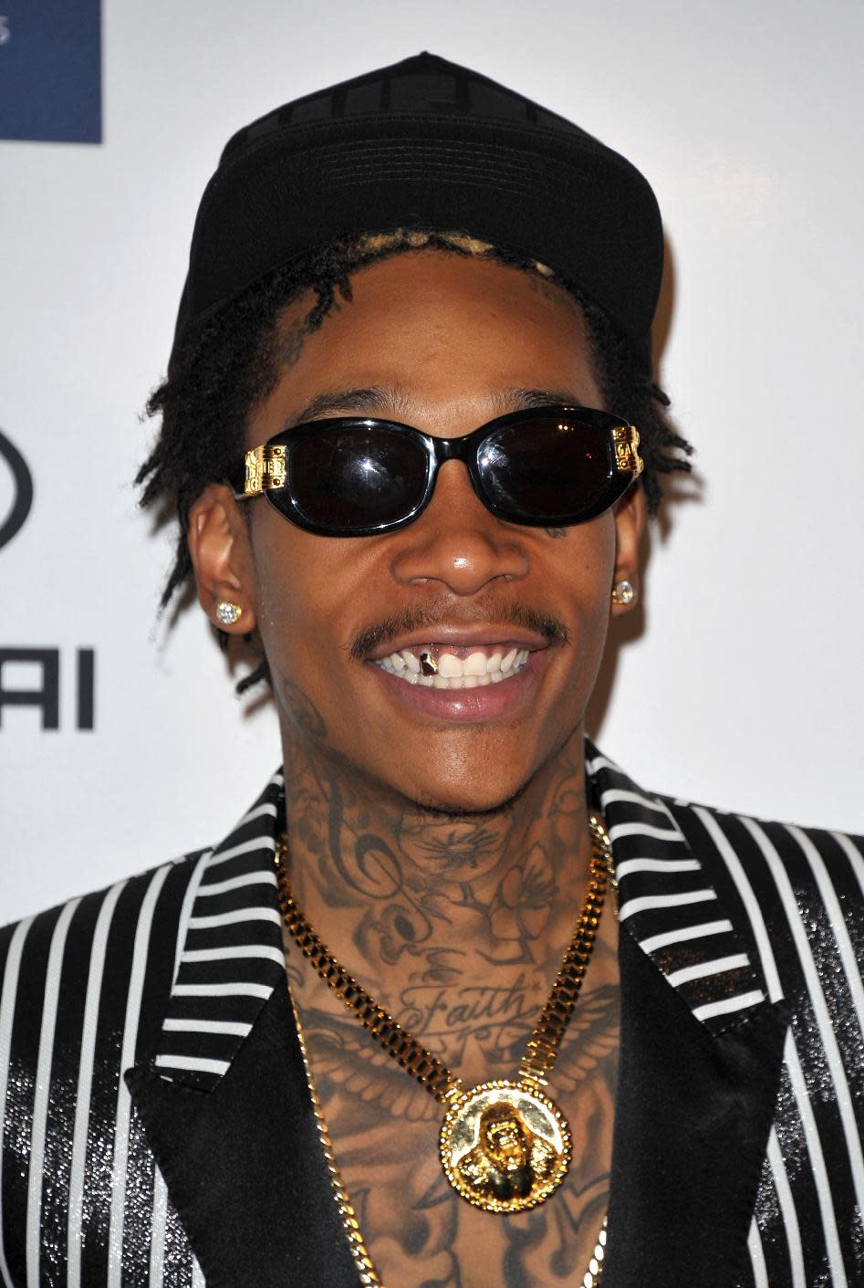 Rapper Wiz Khalifa arrives at the Clive Davis Pre-GRAMMY Gala on Saturday, Feb. 9, 2013 in Beverly Hills, Calif. (Photo by John Shearer/Invision/AP)