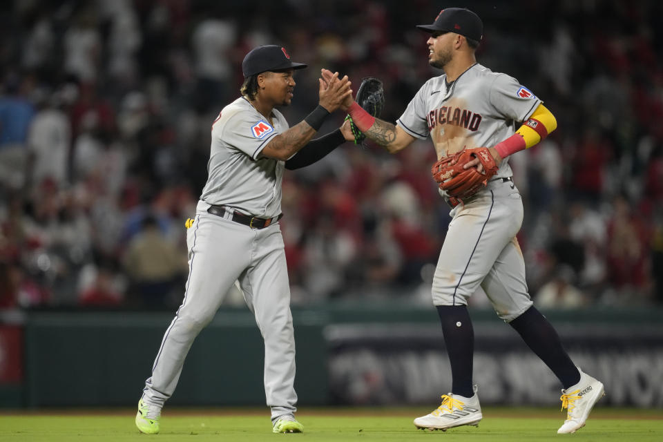 Cleveland Guardians third baseman Jose Ramirez, left, and shortstop Gabriel Arias celebrate after a 6-3 win over the Los Angeles Angels in a baseball game in Anaheim, Calif., Friday, Sept. 8, 2023. (AP Photo/Ashley Landis)
