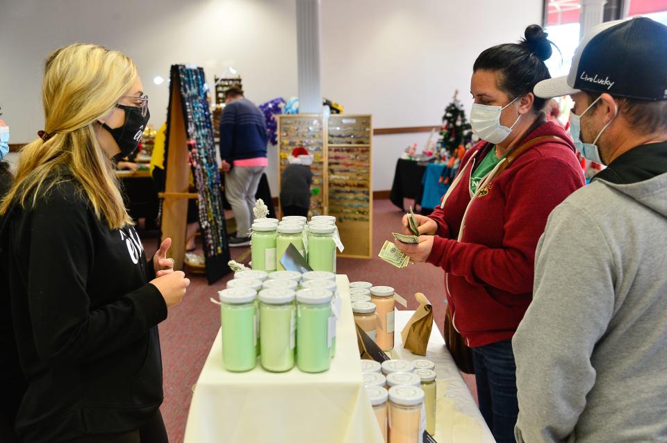 Karen Claudio and her husband Joe make a purchase during Taunton's 2020 Holiday Pop Up Shoppe.