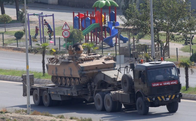 Armoured Turkish army vehicle is transported near the Turkish border town of Ceylanpinar