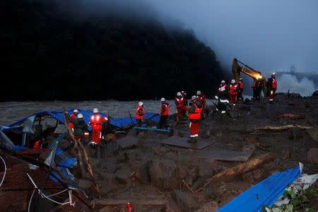 Paramilitary police search for missing people at the site of a landslide in Sanming, Fujian Province, China, May 8, 2016. China Daily/via REUTERS