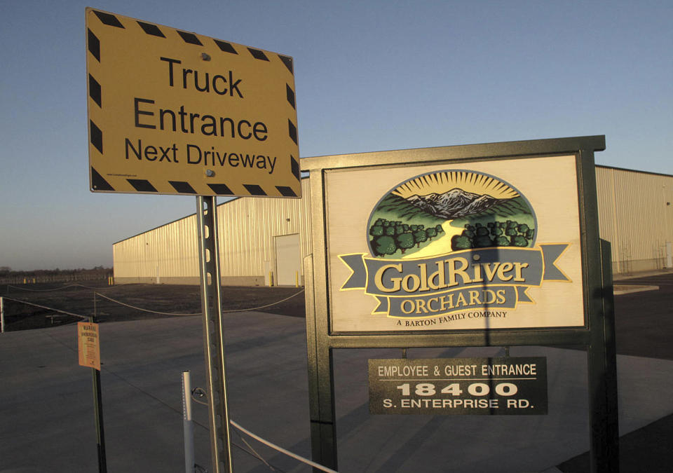 This Thursday, Jan. 16, 2014 photo shows the outside of GoldRiver Orchards, a walnut grower and processor, in Escalon, Calif. The company fell victim in October 2013 to a brazen heist when thieves made off with 140,000 pounds of processed walnuts worth $400,000. Thieves cut through wooden fence posts in the dead of night, hooked up a truck to gondola trailers brimming with nuts and drove off. (AP Photo/Scott Smith)