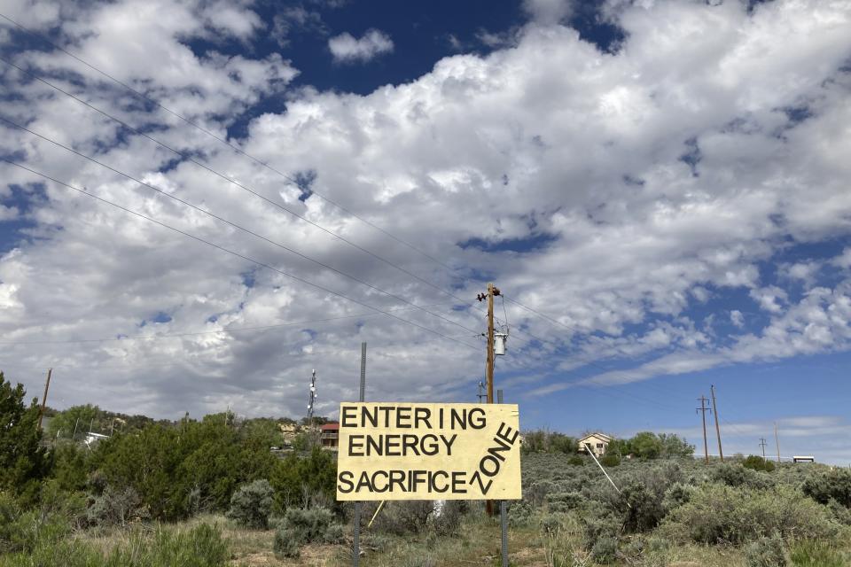 A sign of protest stands on a hillside in Counselor, N.M. On Thursday, June 1, 2023, New Mexico Land Commissioner Stephanie Garcia Richard issued an executive order that includes a ban on all new oil and gas leases on state trust land within a mile of schools or other educational institutions, including day care centers, preschools and sports facilities that students use. (AP Photo/Susan Montoya Bryan)