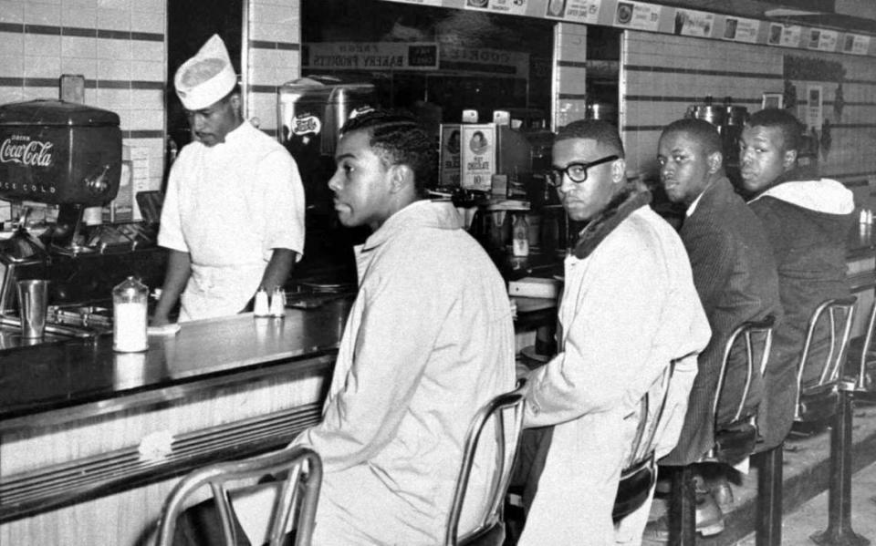 A group of 20 A&T College students occupied lunch counter seats at the downtown F.W. Woolworth Co. store. They are, from left, Joseph McNeil, Franklin McCain, Billy Smith and Clarence Henderson.