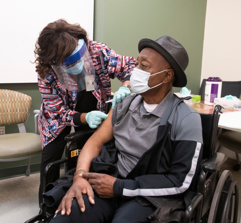 Registered Nurse Linda Hixson prepares to give Joe Knight his first dose of the COVID-19 vaccine on Jan. 12, 2021. Knight, a veteran of the Korean and Vietnam wars, is the first outpatient veteran to receive the new Moderna vaccine at the Joint Ambulatory Care Center in Pensacola, Fla.