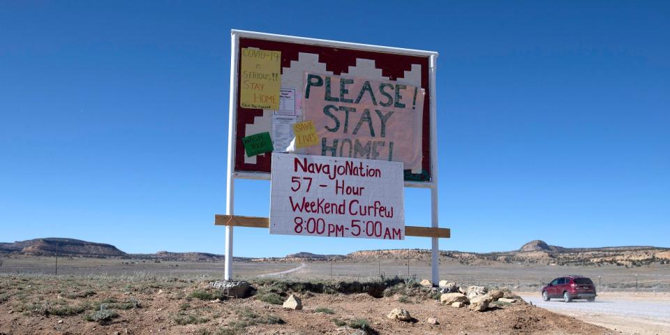 A sign asking Navajo residents to stay safe and warning of a curfew near the Navajo Nation town of Casamero Lake in New Mexico on May 20, 2020.