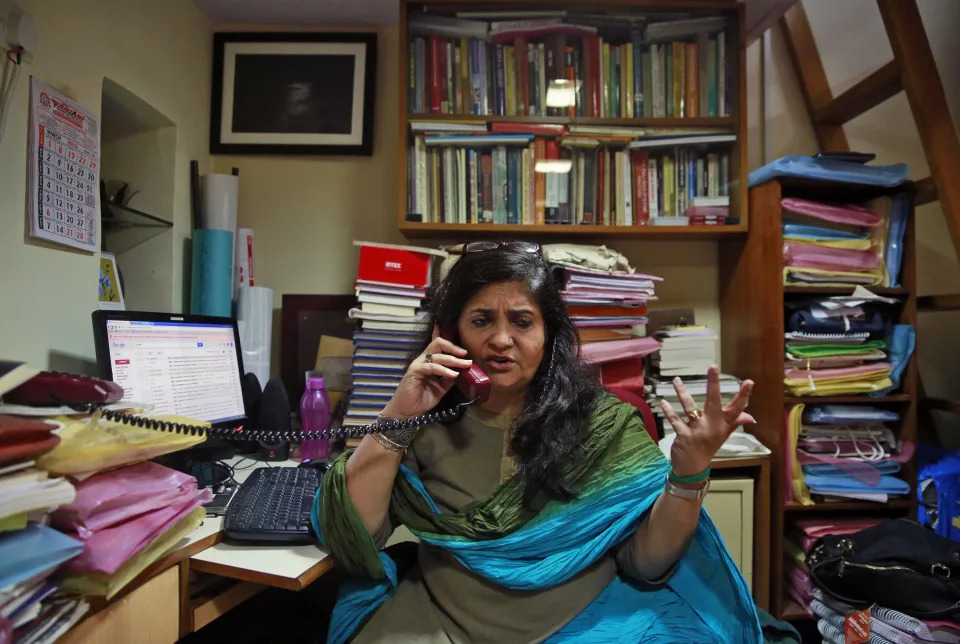 FILE- Teesta Setalvad, a rights activist fighting for scores of survivors and victims of India's western state of Gujarat riots, speaks on phone during an interview with The Associated Press at her office in Mumbai, India, Sept. 7, 2015. Setalvad was arrested by the Gujarat state police’s anti-terrorism wing on Saturday, June 25, 2022, for allegedly “committing forgery and fabricating evidence” in a case about the 2002 anti-Muslim riots in Gujarat state. (AP Photo/Rafiq Maqbool, File)
