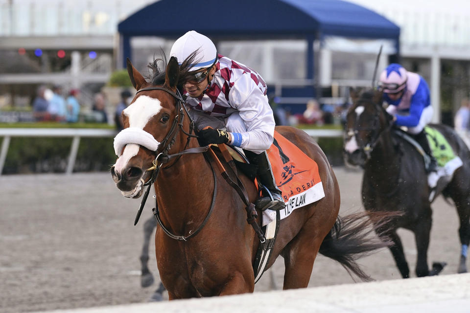 In this image provided by Gulfstream Park, Tiz the Law, riddren by Manuel Franco, wins the Florida Derby horse race at Gulfstream Park, Saturday, March 28, 2020, in Hallandale Beach, Fla. (Derbe Glass/Coglianese Photos, Gulfstream Park via AP)