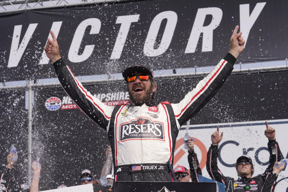 Martin Truex Jr., celebrates his win in the Crayon 301 NASCAR Cup Series auto race, Monday, July 17, 2023, at New Hampshire Motor Speedway, in Loudon, N.H. (AP Photo/Steven Senne)