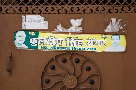 An election campaign sticker is seen on a door at the compound of the house of Kuldeep Singh Sengar, a legislator of the ruling Bharatiya Janata Party (BJP), accused of raping a young woman, in Unnao