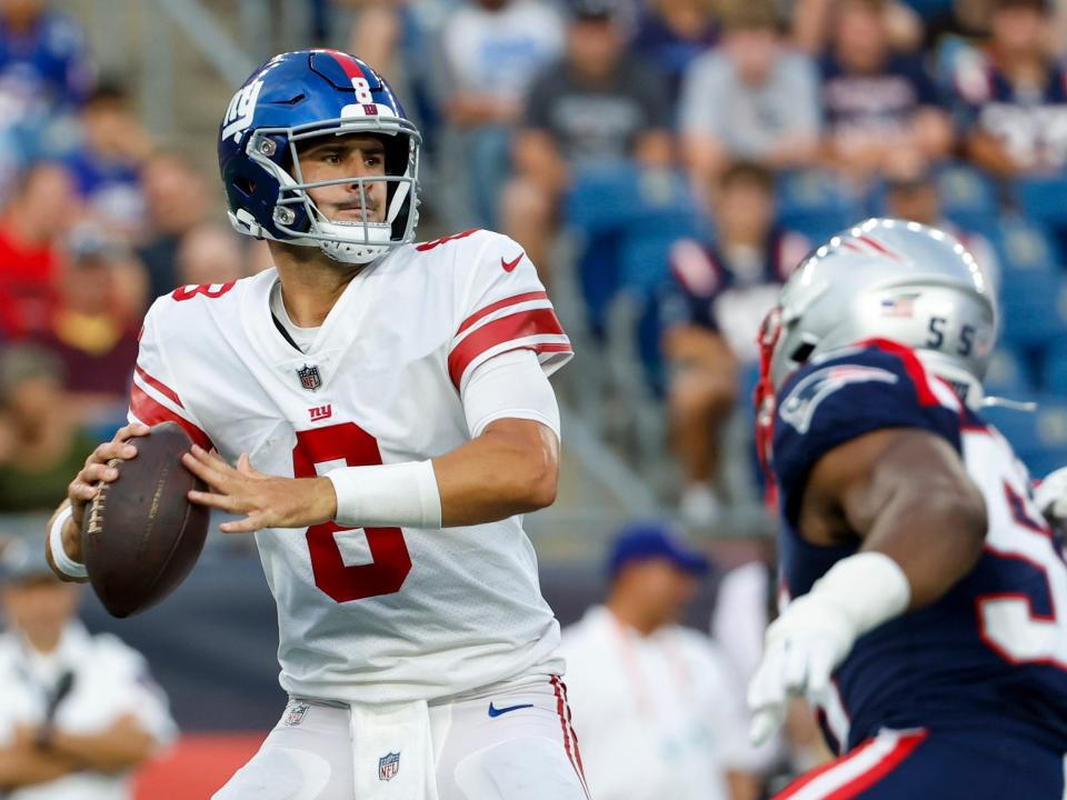 Daniel Jones steps back to throw during a preseason game against the New England Patriots.