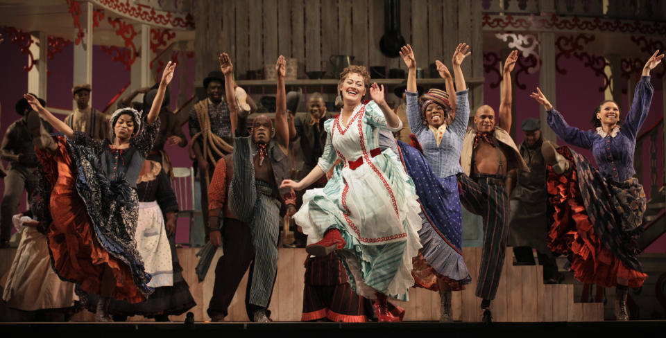 In this photo taken Feb. 9, 2012, Ashley Brown, center, portraying Magnolia Hawkes, dances with cast members at a dress rehearsal during the first act of the Lyric Opera of Chicago's production of "Show Boat." (AP Photo/M. Spencer Green)