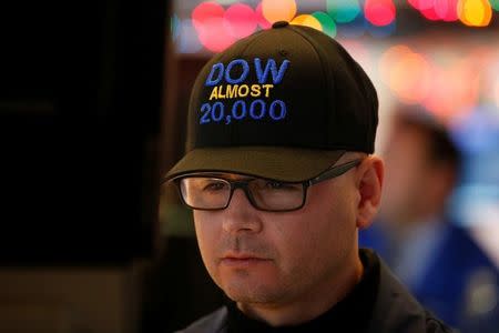 Specialist trader Mario Picone wears a "DOW Almost 20,000" cap as he works at his post on the floor of the New York Stock Exchange (NYSE) in New York City, U.S., December 15, 2016. REUTERS/Brendan McDermid - RTX2V80C