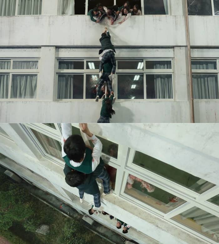 Yoon Chan-young and Park Solomon hang from a window on the outer side of the building and a zombie hangs from the leg of Park Solomon