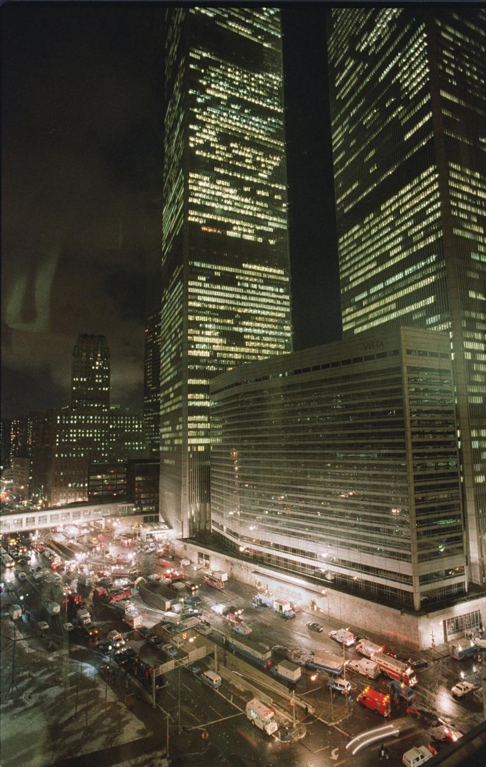 FILE - In this Feb. 26, 1993 file photo, fire, police and other emergency vehicles block the street near the twin towers of New York's World Trade Center after an explosion in the underground parking garage. New York City is marking the anniversary of the 1993 bombing that blew apart a van parked in an underground garage, killing six people and injured more than 1,000. The Port Authority of New York and New Jersey is holding a memorial Mass on Monday, Feb. 26, 2024 at St. Peter’s Church in Manhattan. (AP Photo/George Widman, File)