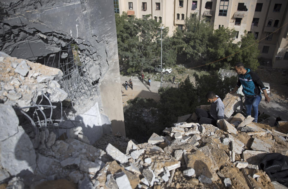 Palestinians inspect the damage of a destroyed house following a late night Israeli missile strike in town of Beit Lahiya, Northern Gaza Strip, Monday, May. 6, 2019. The Israeli military has lifted protective restrictions on residents in southern Israel while Gaza's ruling Hamas militant group reported a cease-fire deal had been reached to end the deadliest fighting between the two sides since a 2014 war. (AP Photo/Khalil Hamra)