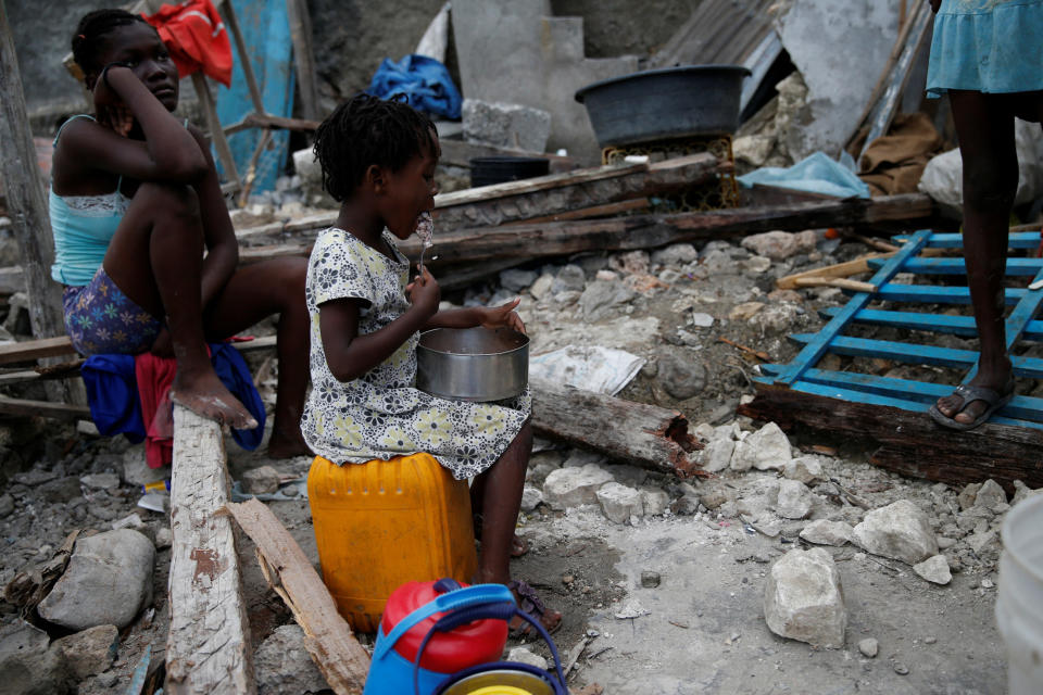 A girl eats at her destroyed house on&nbsp;Oct. 15, 2016.