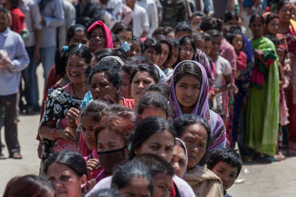 Residents line up for food in an evacuation area set up by the authorities in Tundhikel park on April 27, 2015 in Kathmandu, Nepal.  (Photo by Omar Havana/Getty Images)