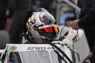Josef Newgarden climbs into his car during testing at the Indianapolis Motor Speedway, Thursday, April 8, 2021, in Indianapolis. (AP Photo/Darron Cummings)