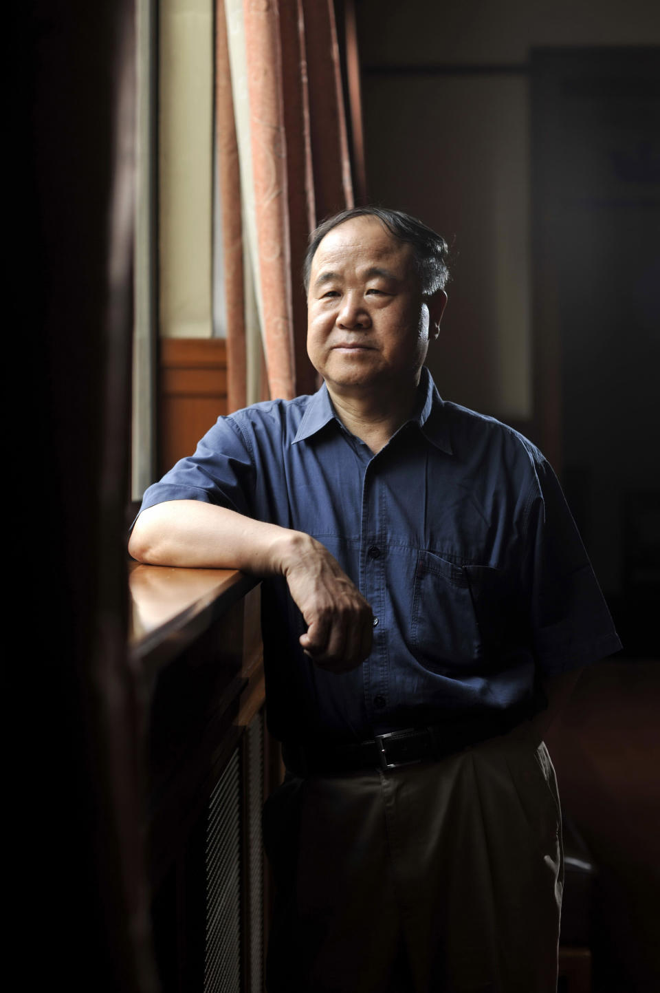 In this photo taken Tuesday Aug. 2, 2011, Chinese writer Mo Yan poses for photos in a theater in Beijing. Mo was awarded the Nobel Prize in literature on Thursday, Oct 11, 2012, a cause of pride for a government that had disowned the only previous Chinese winner of the award, an exiled critic. (AP Photo) CHINA OUT