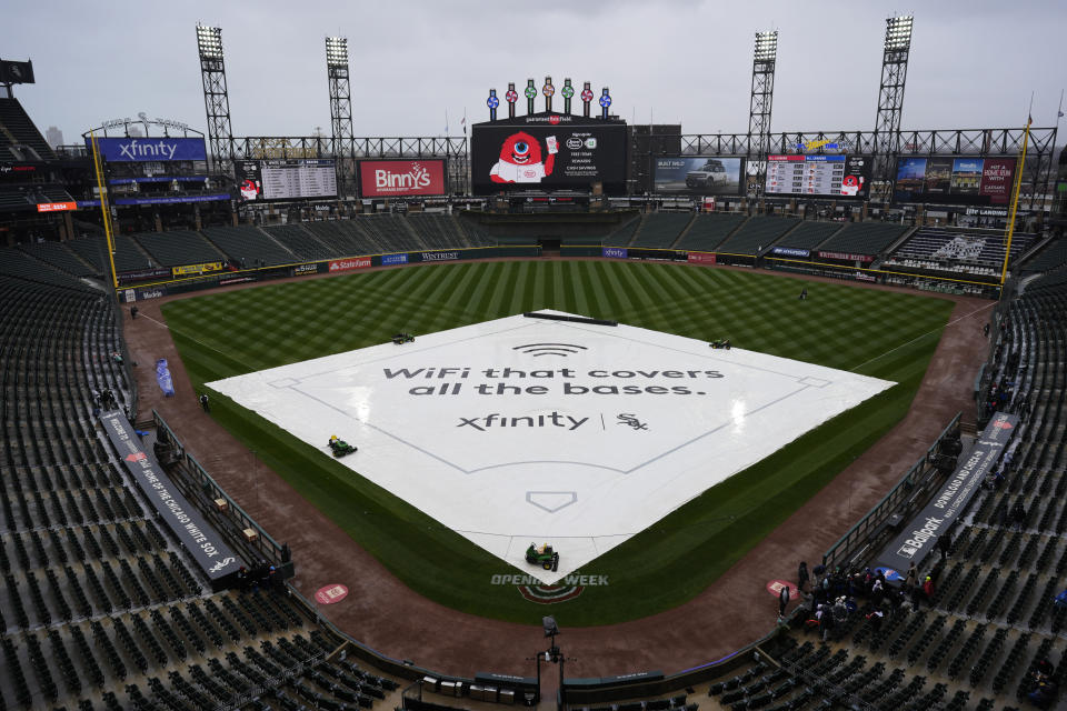 The tarp covers the infield before a baseball game between the Chicago White Sox and the Atlanta Braves in Chicago, Wednesday, April 3, 2024. (AP Photo/Nam Y. Huh)