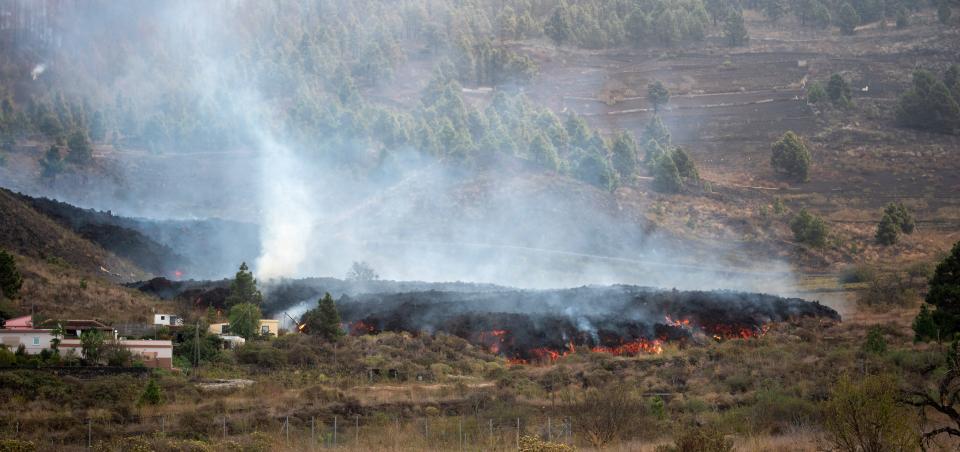 Smoke rises from cooling lava in the residential area of Los Campitos at Los Llanos de Aridane, on the Canary Island of La Palma on September 20, 2021. - A surge of  lava destroyed around 100 homes on Spain's Canary Islands a day after a volcano erupted, forcing 5,000 people to leave the area. The Cumbre Vieja erupted on Sunday, sending vast plumes of thick black smoke into the sky and belching molten lava that oozed down the mountainside on the island of La Palma. (Photo by DESIREE MARTIN / AFP) (Photo by DESIREE MARTIN/AFP via Getty Images)