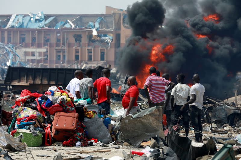 People gather with their belongings at the scene of the fire outbreak at Abule-Ado in Lagos