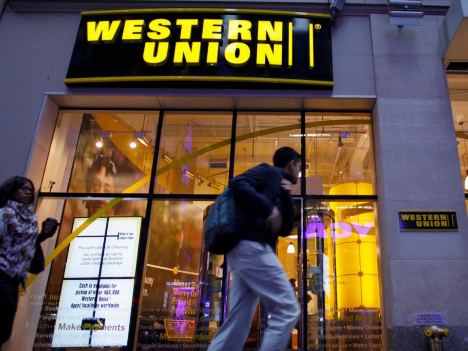 People walk past a Western Union location