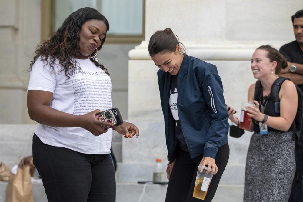 Rep. Cori Bush, D-Mo., and Rep. Alexandria Ocasio-Cortez, D-N.Y., have an impromptu dance party to “Run the World (Girls)” by Beyonce after it was announced that the Biden administration will enact a targeted nationwide eviction moratorium outside of Capitol Hill in Washington on Tuesday, August 3, 2021. (AP Photo/Amanda Andrade-Rhoades)