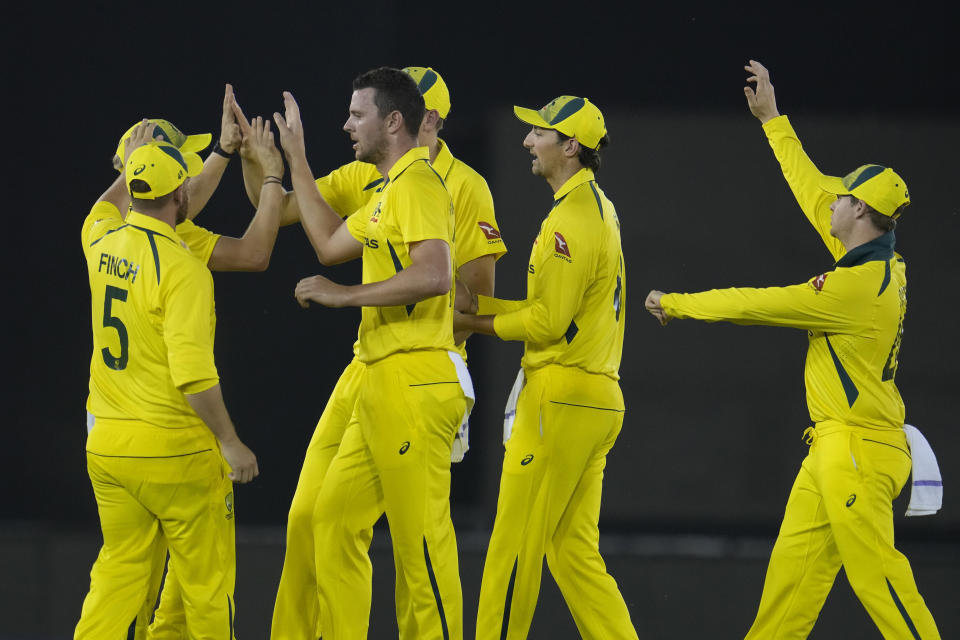 Australia's Josh Hazlewood, center without cap, celebrates with teammates the dismissal of India's captain Rohit Sharma during the first T20 cricket match between India and Australia, in Mohali, India, Tuesday, Sept. 20, 2022. (AP Photo/Manish Swarup)