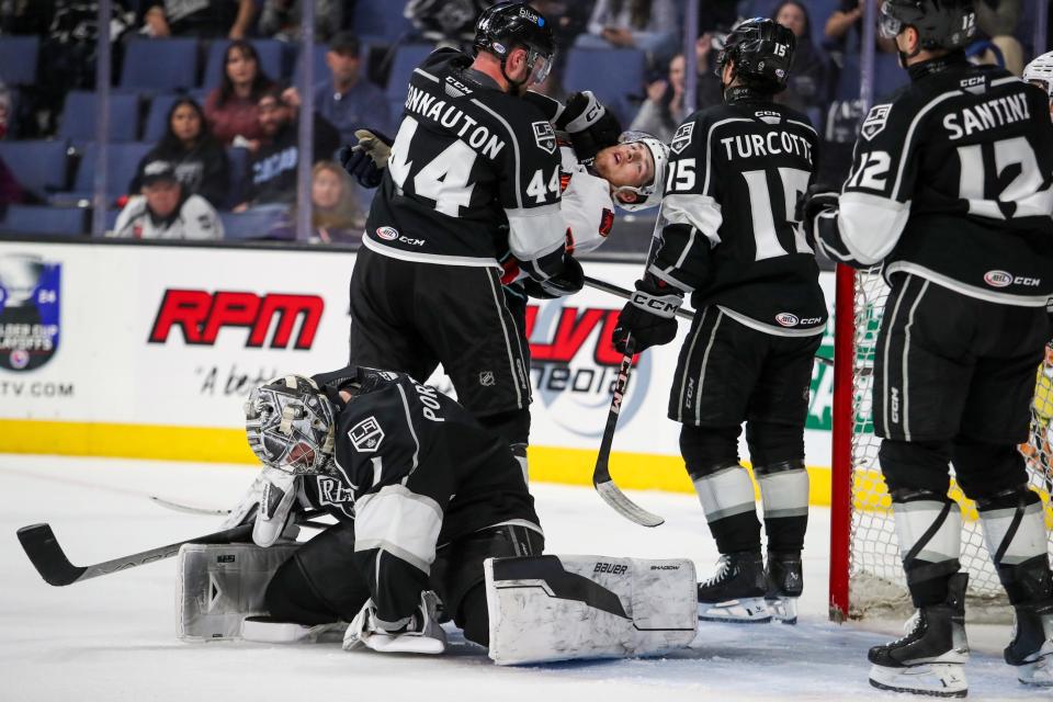 Ontario Reign defenseman Kevin Connauton (44) punches Coachella Valley Firebirds forward Jacob Melanson (63) during Game 3 of the Pacific Division Finals at the Toyota Arena in Ontario, Calif., on Sunday, May 19, 2024.