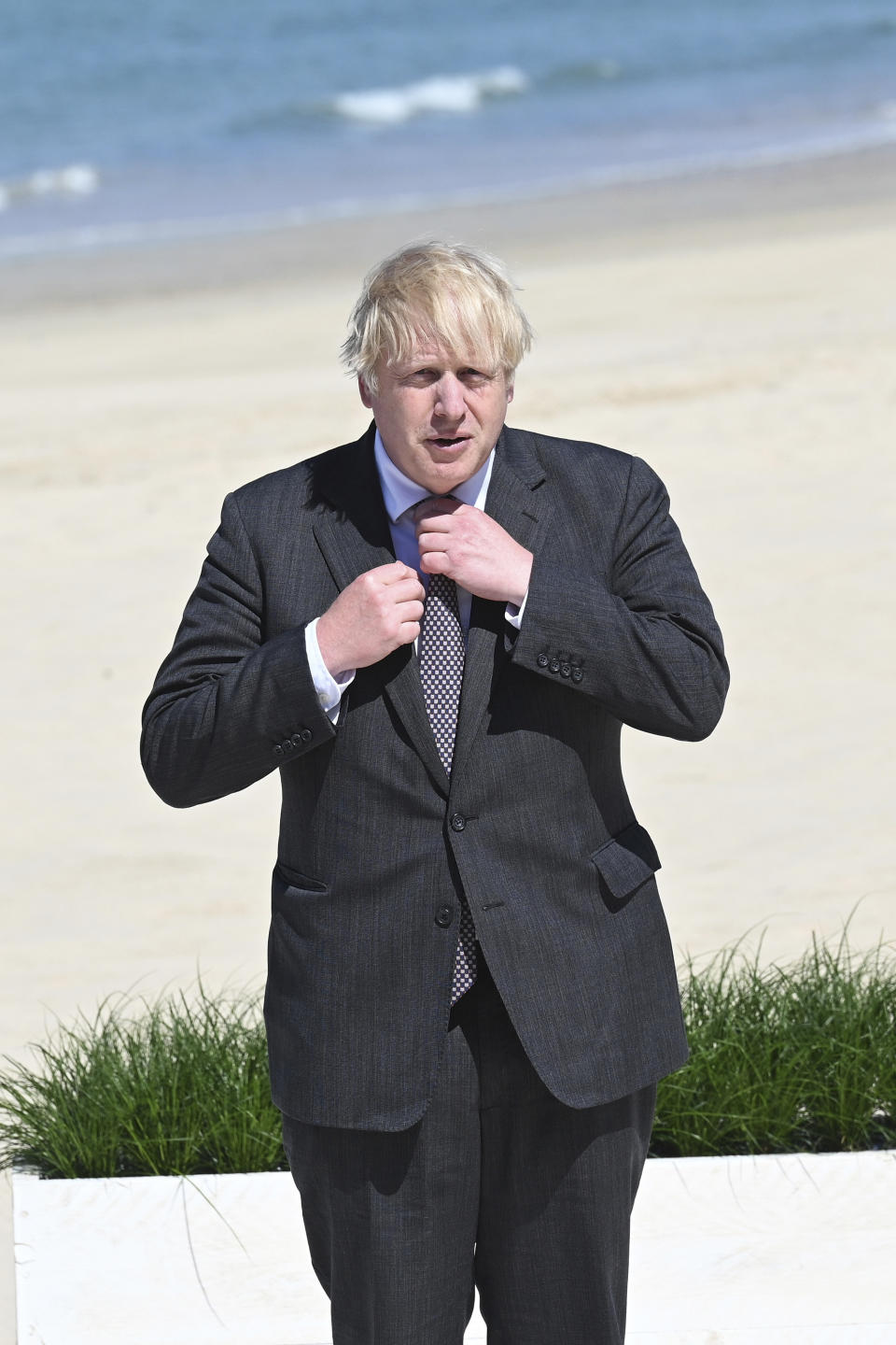 Britain's Prime Minister Boris Johnson waits to greet guests at an official welcome at the G7 summit in Carbis Bay, Cornwall, England, Saturday, June 12, 2021. (Leon Neal/Pool Photo via AP)