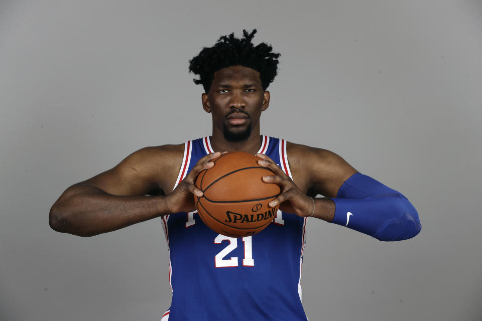 Joel Embiid can still squeeze a basketball from the sidelines. (AP)