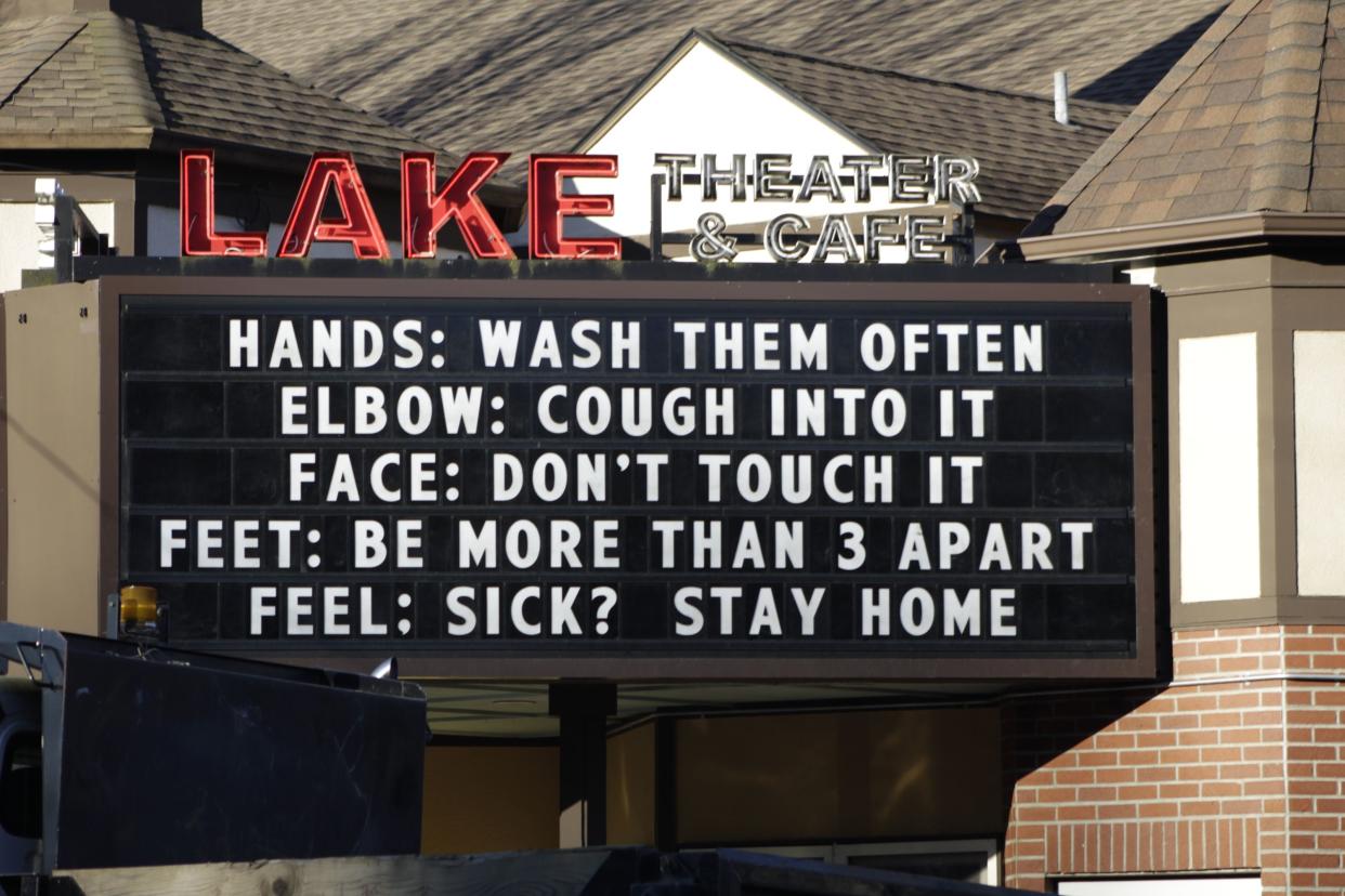 A marquee outside the Lake Theater & Café in Lake Oswego, Ore., offers advice on how not to spread germs Tuesday, March 17, 2020. Oregon Gov. Kate Brown on Monday banned on-site consumption at bars and restaurants around the state for at least four weeks in a bid to slow the spread of the new coronavirus and said gatherings will be limited to 25 people or fewer.