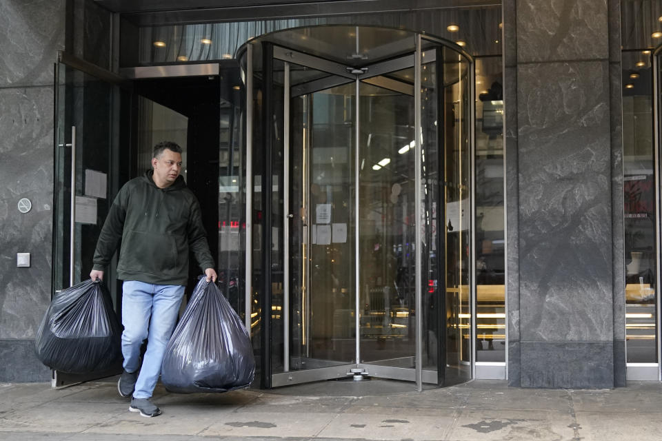 An immigrant from Colombia leaves the Row Hotel with his belongings, Tuesday, Jan. 9, 2024, in New York. (AP Photo/Mary Altaffer)