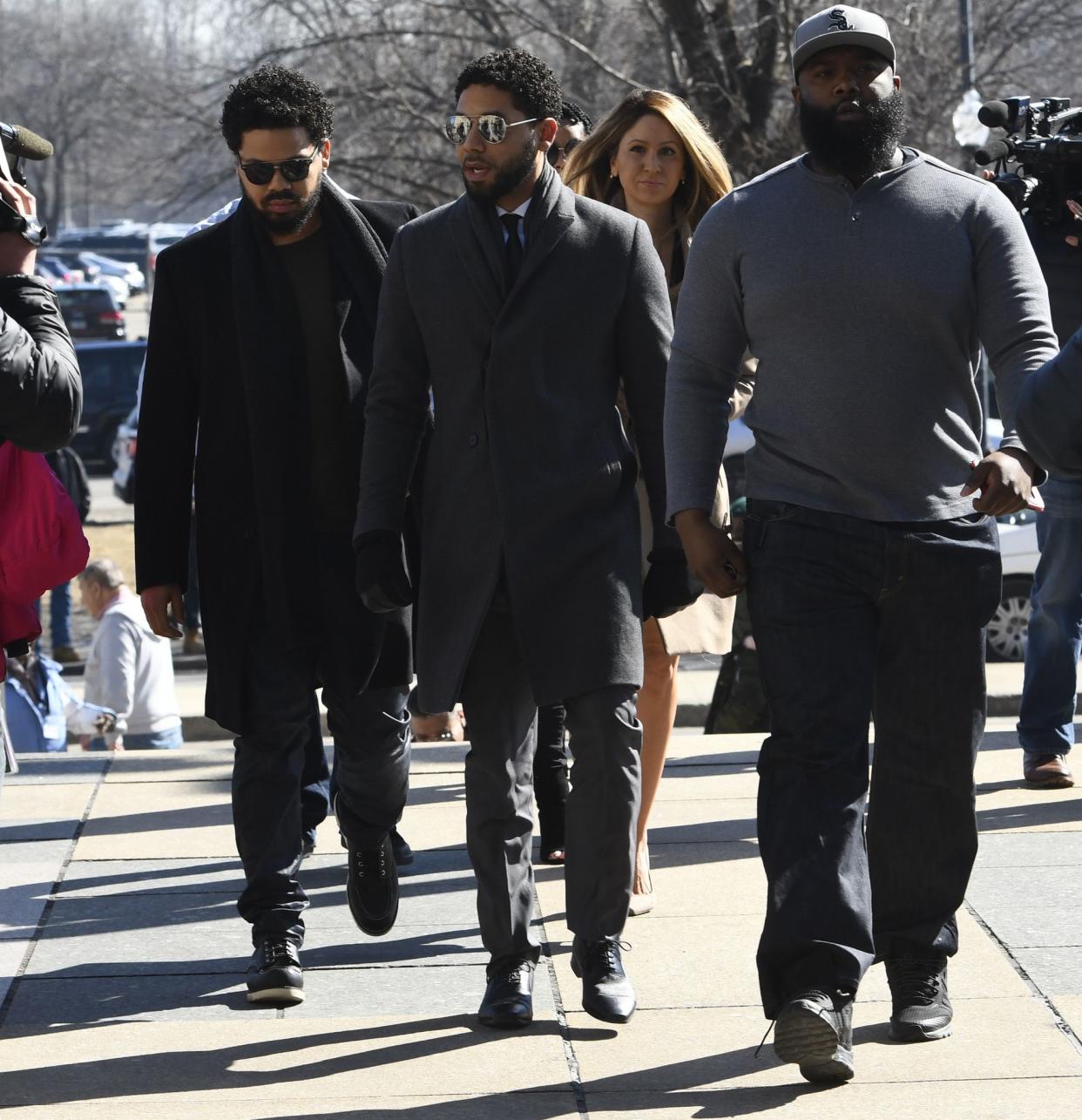 "Empire" actor Jussie Smollett, center, arrives at Leighton Criminal Court Building for a hearing to discuss whether cameras will be allowed in the courtroom during his disorderly conduct case on Tuesday, Mar. 12, 2019, in Chicago.