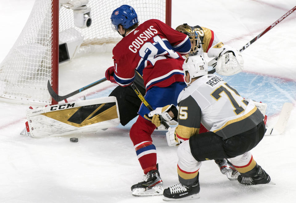 Montreal Canadiens' Nick Cousins (21) scores against Vegas Golden Knights goaltender Marc-Andre Fleury as Knights' Ryan Reaves defends during first-period NHL hockey game action in Montreal, Saturday, Jan. 18, 2020. (Graham Hughes/The Canadian Press via AP)