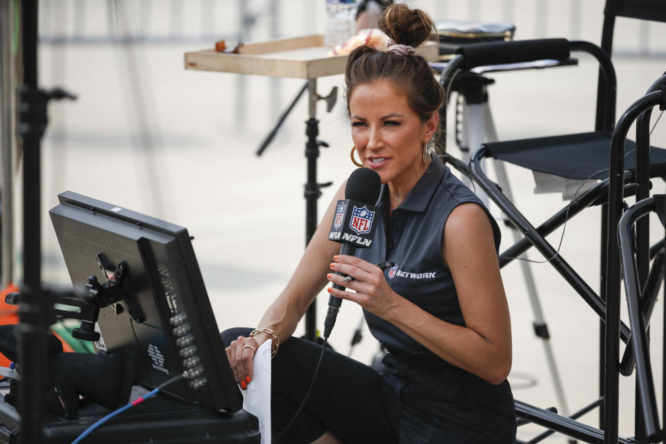 NFL Network reporter Kay Adams prepares to go on the air outside of Lambeau Field during NFL football training camp Saturday, July 31, 2021, in Green Bay, Wis. (AP Photo/Matt Ludtke)