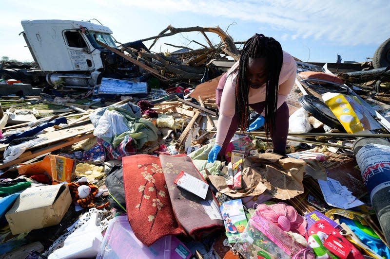 Kimberly Patton surveys through the belongings at the spot of a family member’s home after a tornado destroyed the property two days earlier, Sunday, March 26, 2023, in Rolling Fork, Mississippi.