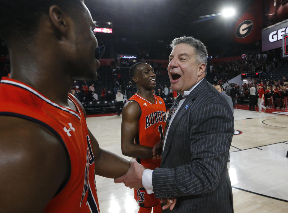 Auburn head coach Bruce Pearl celebrates with guards Davion Mitchell, left, and Jared Harper (1) in the second half of an NCAA college basketball game, Saturday, Feb. 10, 2018, in Athens, Ga. Auburn won 78-61. (AP Photo/John Bazemore)