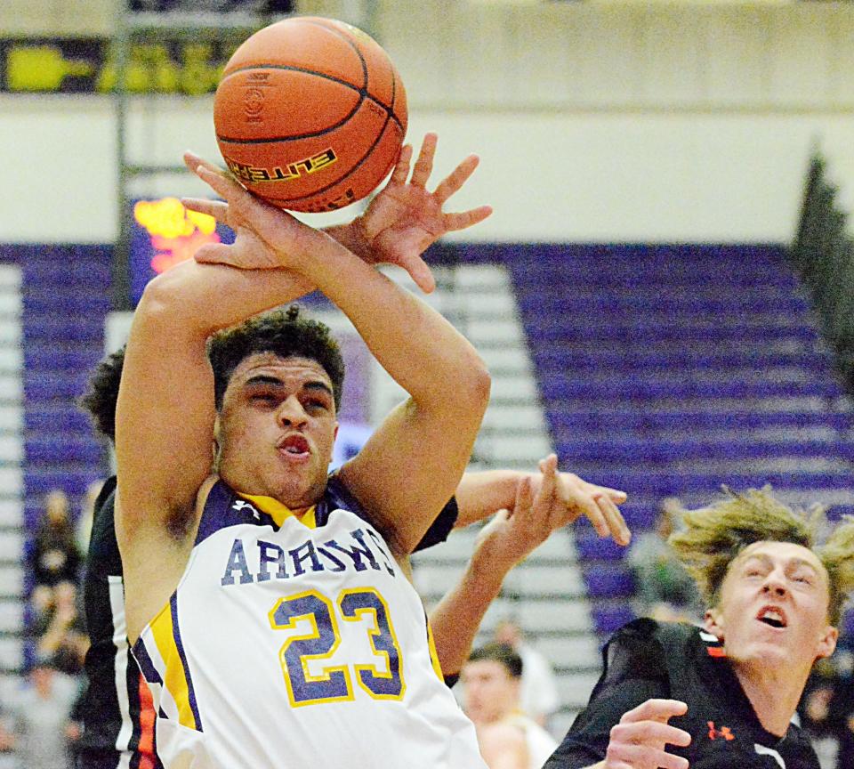 Watertown's Devon Lewis (23) attempts to corral a rebound against Huron's Isaiah Decker (back) and Roger Puterbaugh during their Eastern South Dakota Conference boys basketball game Tuesday night in the Civic Arena. Watertown won 59-44.