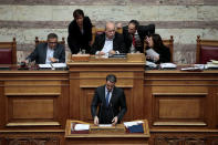 Greek conservative New Democracy party leader Kyriakos Mitsotakis addresses lawmakers as Parliament Speaker Nikos Voutsis chairs a parliamentary session before a vote on setting up a special committee which will probe the role of ten politicians in a case which involves alleged bribery by Swiss drugmaker Novartis, in Athens, Greece, February 21, 2018. REUTERS/Alkis Konstantinidis TPX IMAGES OF THE DAY