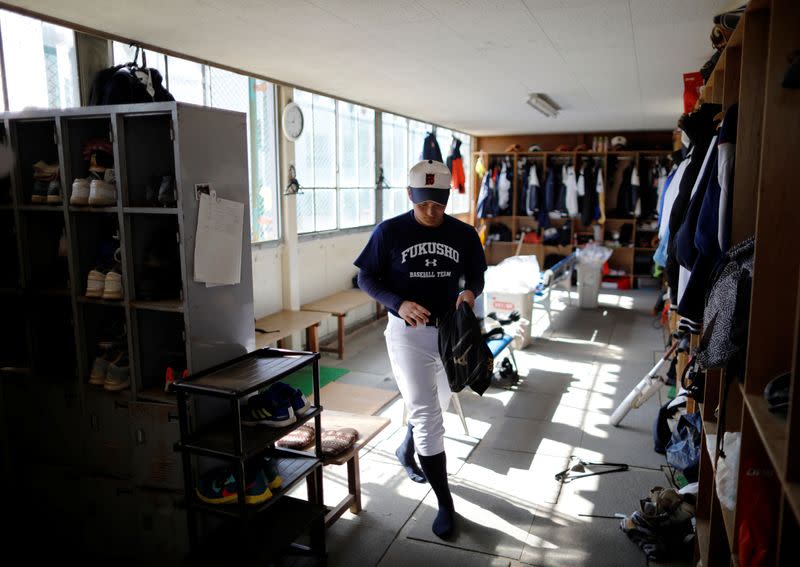 Ryoma Ouchi, an ace pitcher at Fukushima Commercial High School baseball team from Iitate, prepares for a workout at the clubhouse of the team in Fukushima, Japan